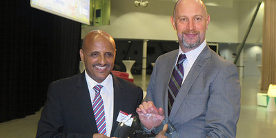 Philip Scruggs and Tewolde GebreMariam posing for a photo op.